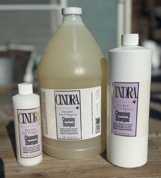 Cindra Cleansing Shampoo bottles in multiple sizes, showing residue-free dog shampoo formulated for show-ring cleanliness.