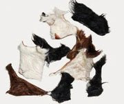 Assorted natural dog chews including chips, chunks, and scraps on white background, mixed beef and hide treats by Cindra Pet Products